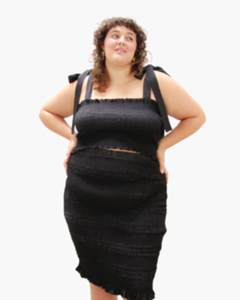 Front of a model wearing a size L Cinch Me Smocked Skirt in BLACK by Lovefool. | dia_product_style_image_id:249598